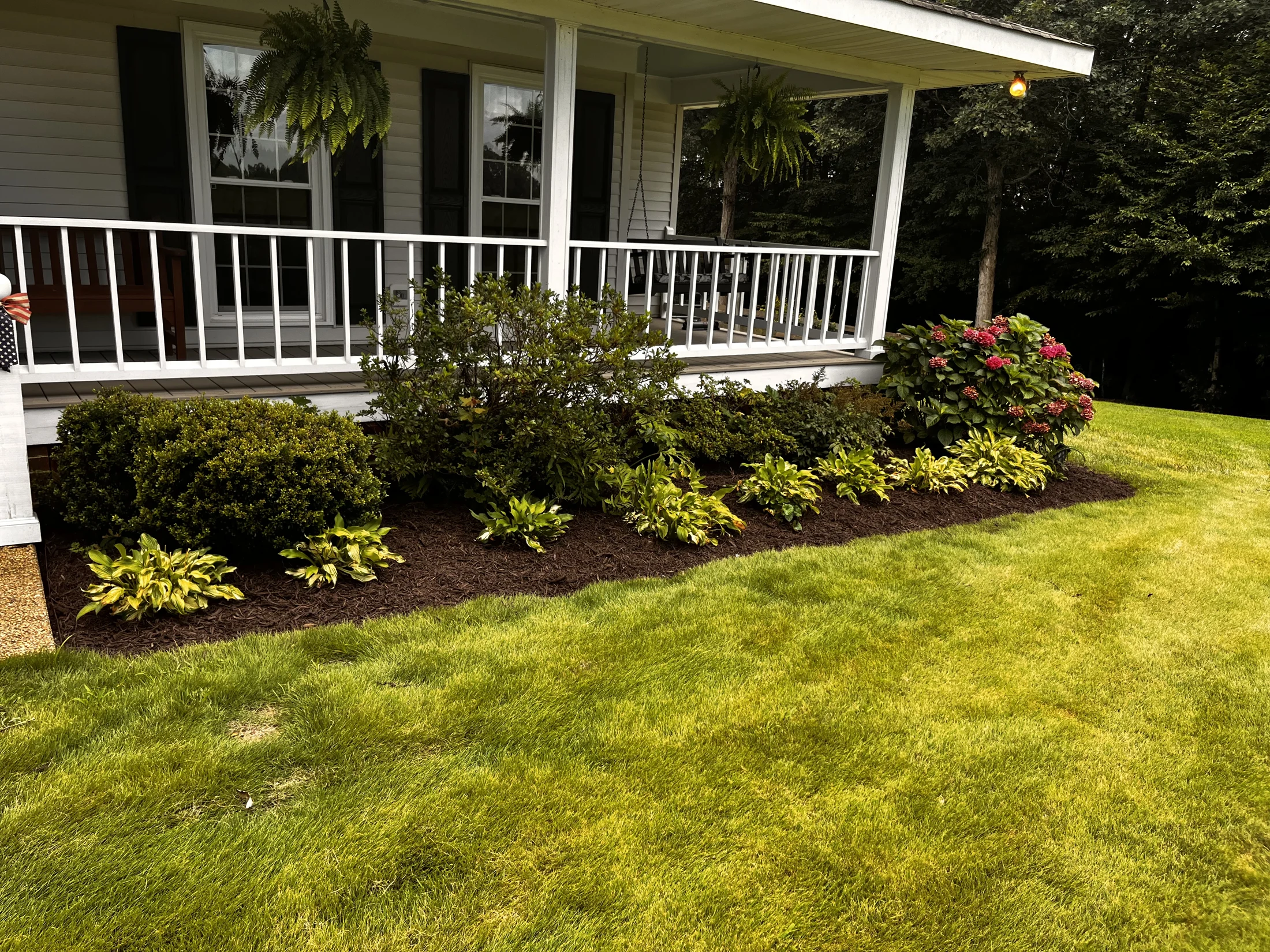 Fresh planting beds along a front porch