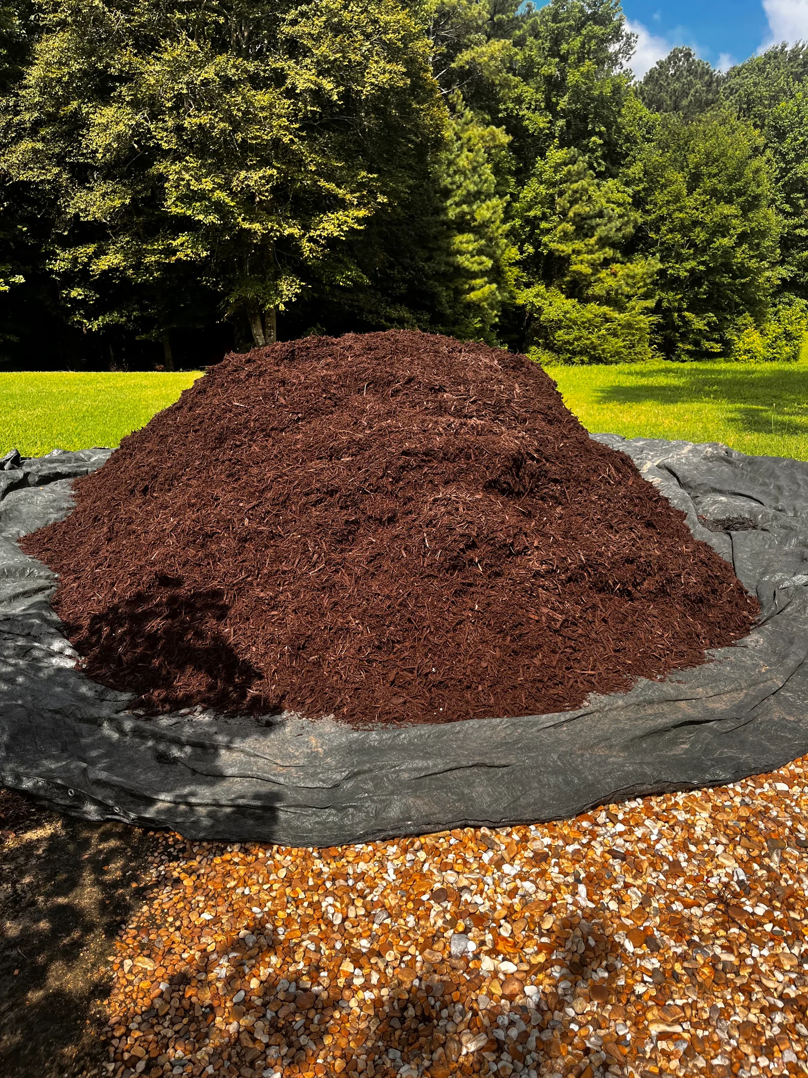 Pile of mulch on a ground sheet at a residential landscape project