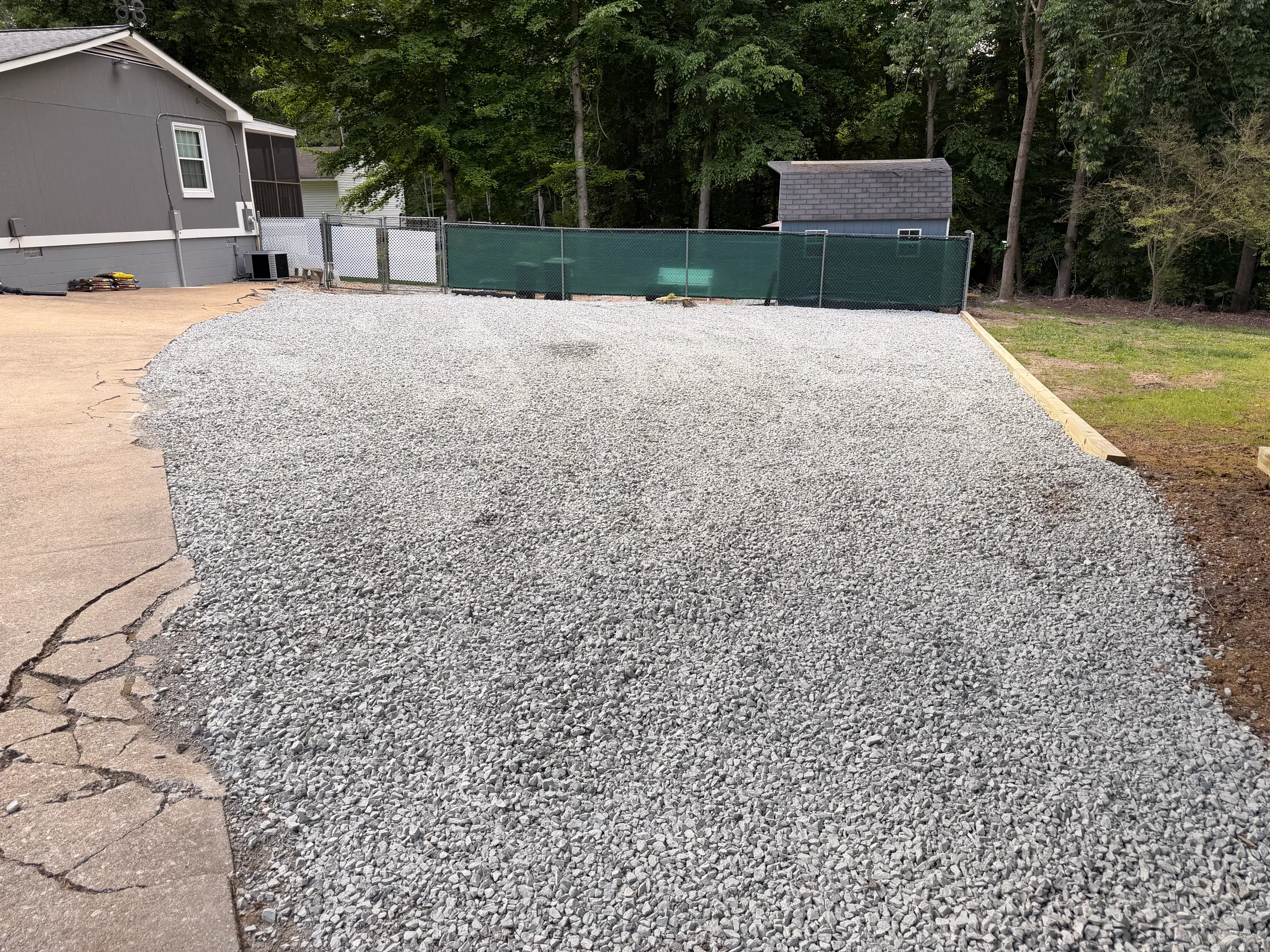 Gravel driveway meeting the surrounding lawn