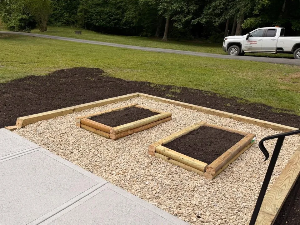 Two timber raised garden beds set within a pale stone surface
